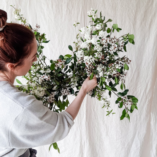 Florist creating a foam-free hanging botanical feature.