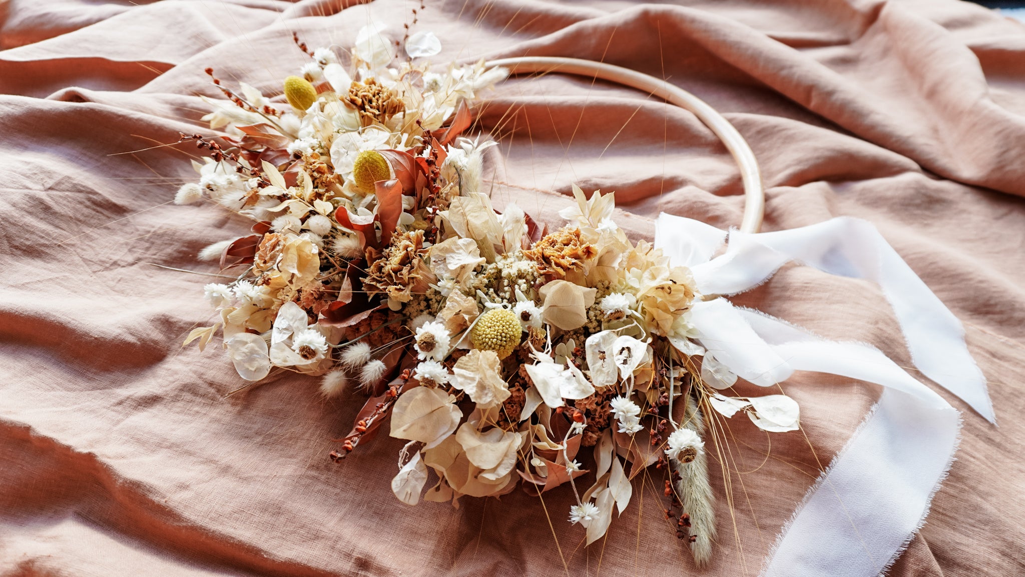 Dried flower wreath in warm apricot tones.