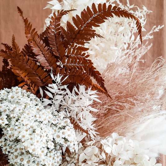 Preserved flowers and foliage in a bunch.