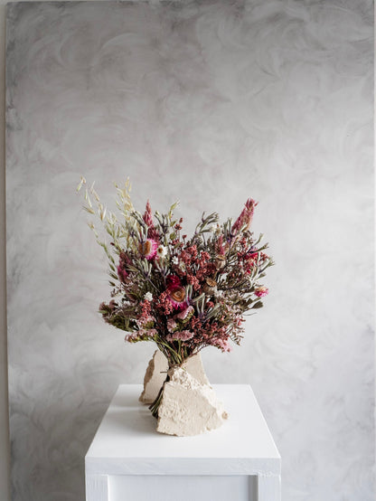 Dried flower bouquet in vibrant colours on a white plinth against a gray background - Classic Size distant view.