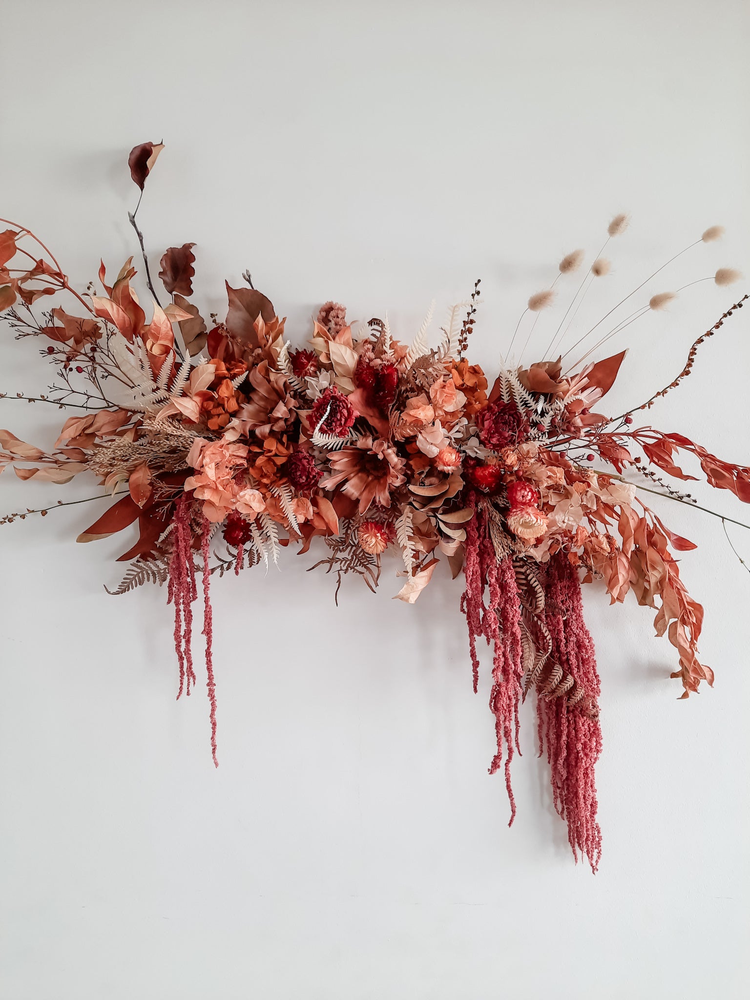 Dried flower wall hanging in Autumnal tones.