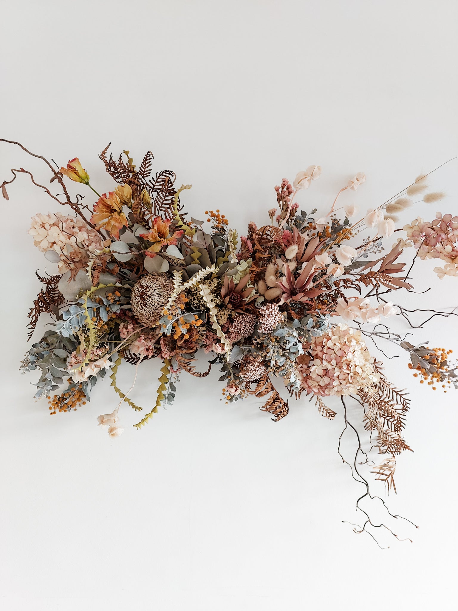 Dried flower wall hanging in pastel tones – close full view.