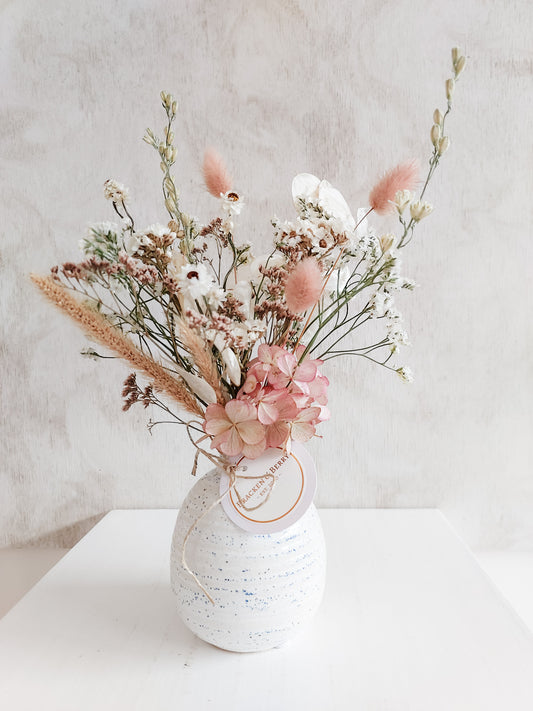 Dried flower arrangement in bud vase with pastel toned florals – close full view.