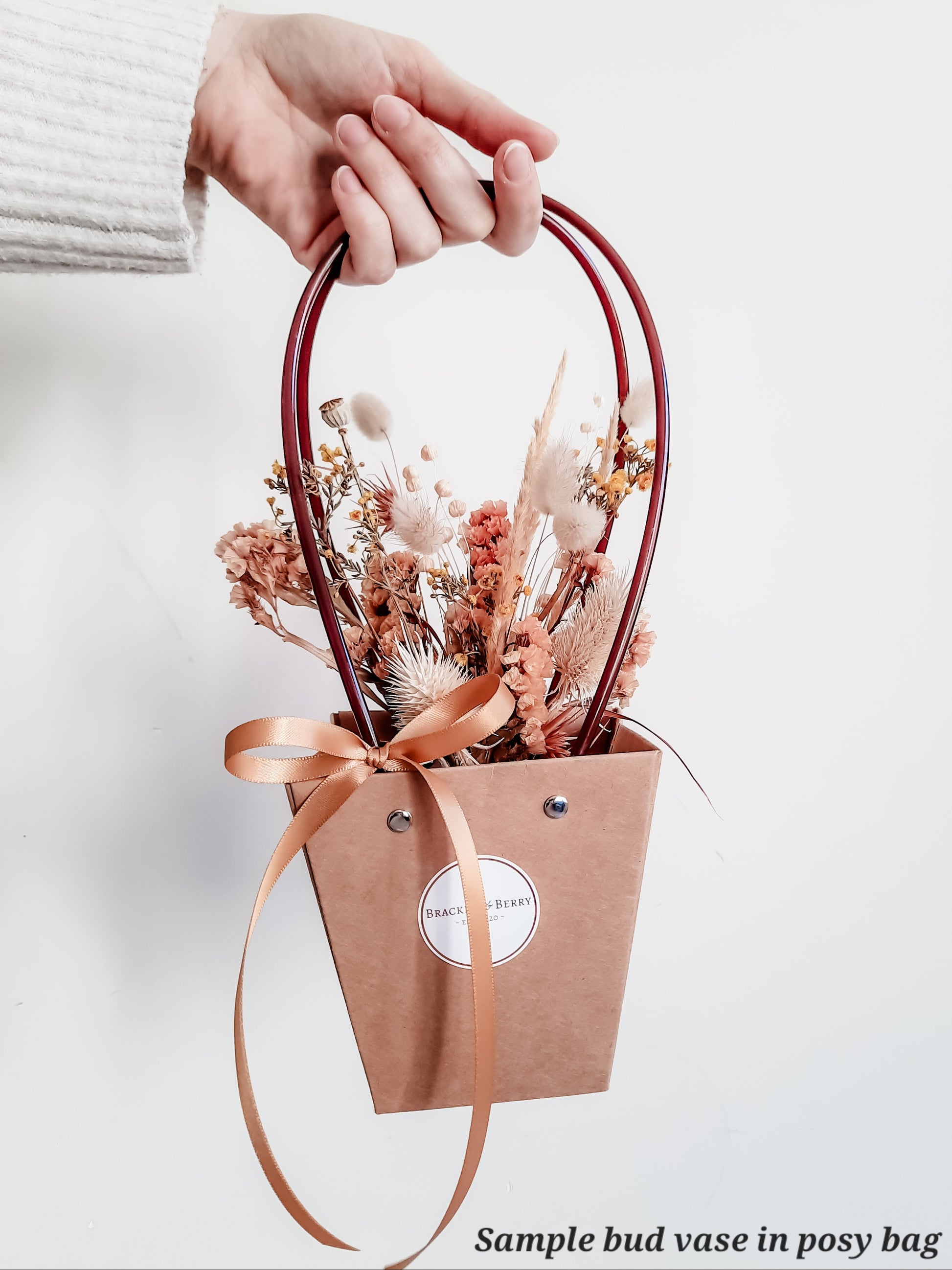 Dried flower arrangement in bud vase with orange florals – vase presented in gift bag.