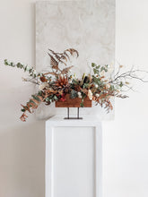 Load image into Gallery viewer, Dried flower centrepiece in rustic vase featuring natural textural florals – front distant view 2.
