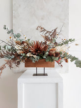 Load image into Gallery viewer, Dried flower centrepiece in rustic vase featuring natural textural florals –back view 1.
