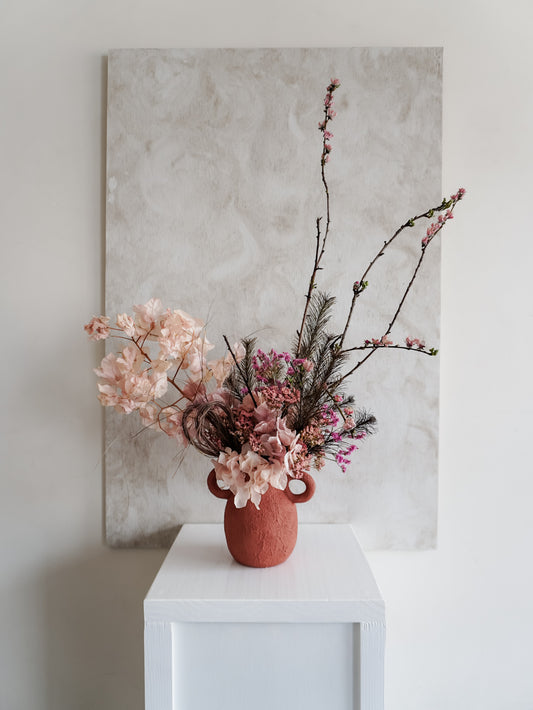 Dried flower arrangement in ceramic urn vase with rich berry tone florals – fulll view.