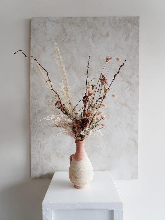 Dried flower arrangement in ceramic vessel with neutral textural florals – full view.