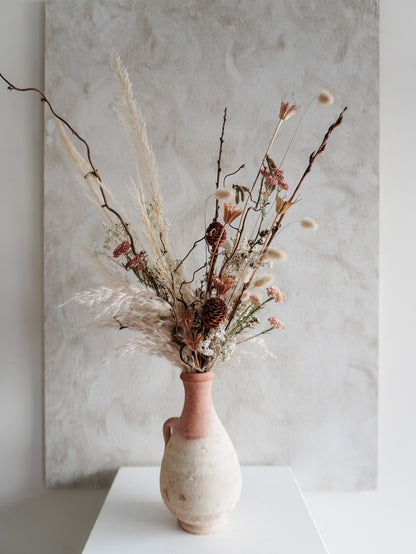 Dried flower arrangement in ceramic vessel with neutral textural florals – close view.