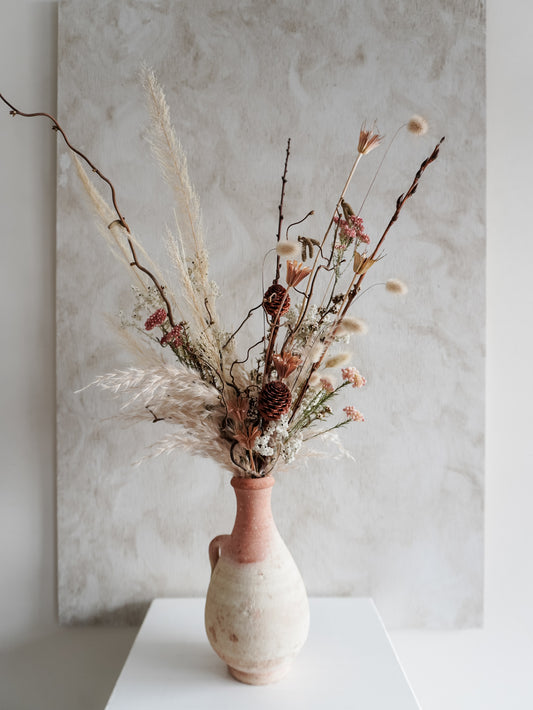 Dried flower arrangement in ceramic vessel with neutral textural florals – close view.