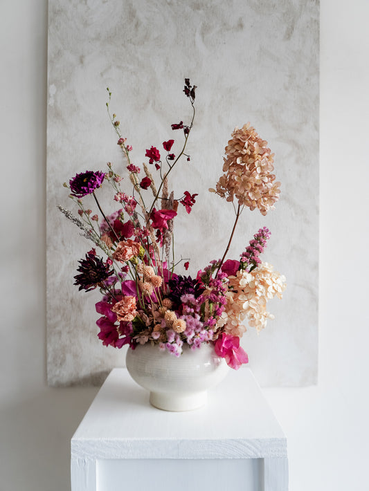 Dried flower arrangement in ceramic vase with deep pink florals – full view.