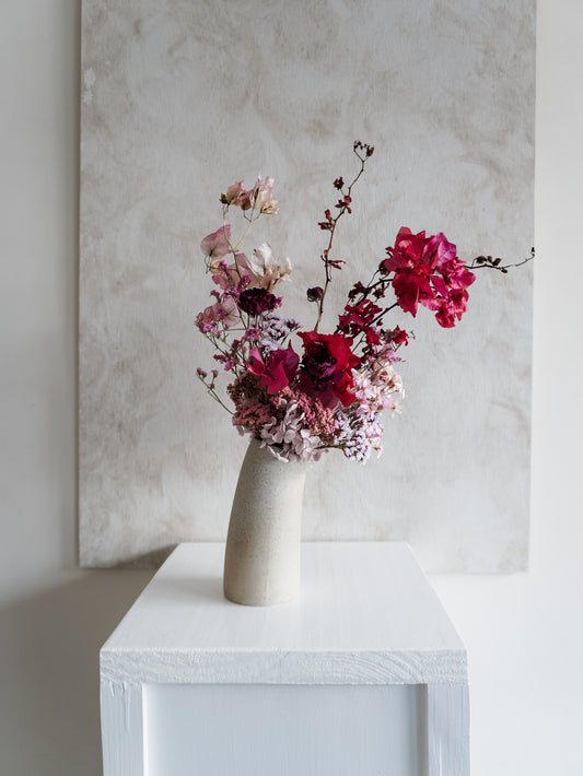 Dried flower arrangement in ceramic vase with deep pink florals – full view.