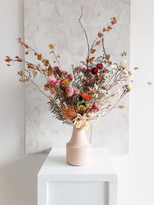 Dried flower arrangement in metal vase with bright colourful florals – full view.