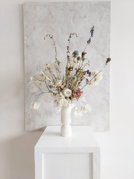 Dried flower arrangement in ceramic vase with whimsical florals – full distant view.