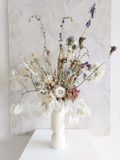 Dried flower arrangement in ceramic vase with whimsical florals – close full view.