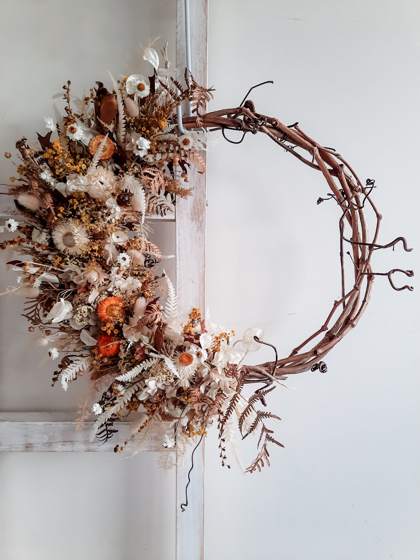 Dried flower wreath in neutral and golden tones on a grapevine base - golden anniversary gift.