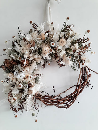 Dried flower wreath in natural, rustic style on a grapevine base.