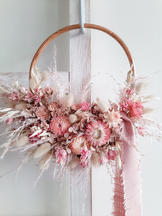 Dried flower wreath in soft pink tones on a small rattan hoop - baby girl gift.